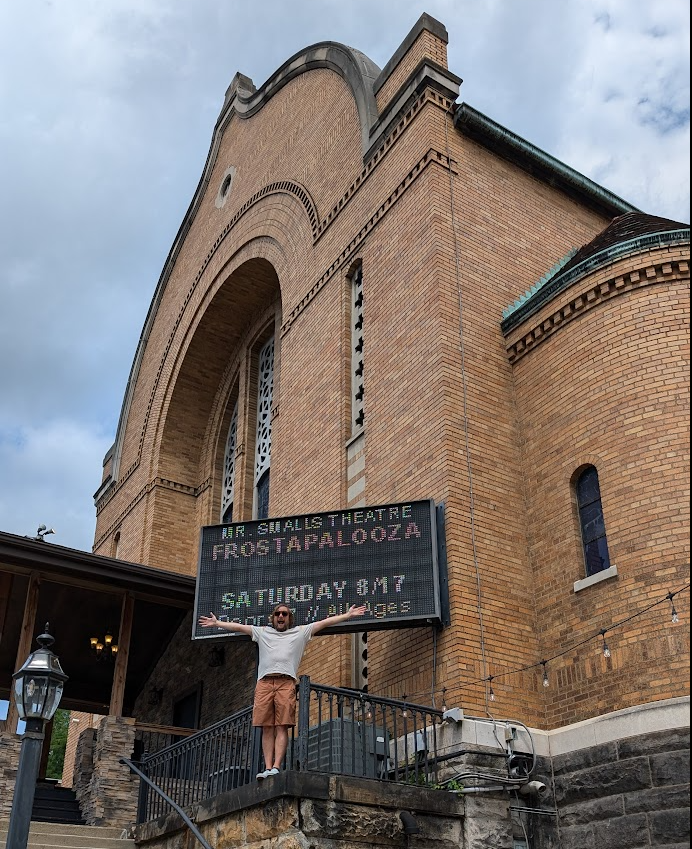 Brad posing in front of Mr Smalls Theatre with marquee that reads "FROSTAPALOOZA: SATURDAY 8/17"